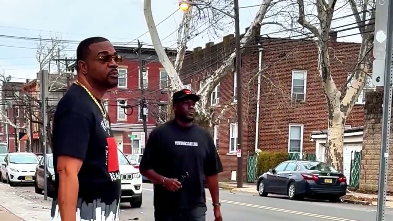 Two men standing on a residential block during production of COPY